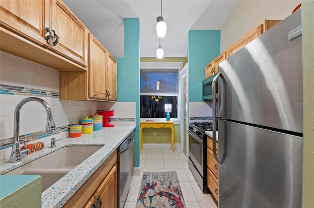 941 Virginia Dr, Sarasota, FL 34234 - kitchen with stainless steel appliances, a sink, backsplash, light tile patterned floors, and light stone countertops