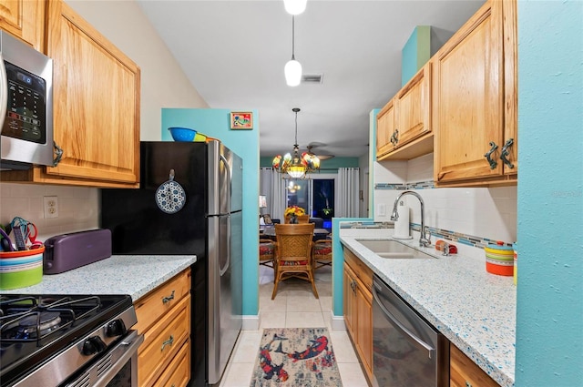 941 Virginia Dr, Sarasota, FL 34234 - kitchen featuring stainless steel appliances, a sink, tasteful backsplash, and light tile patterned floors