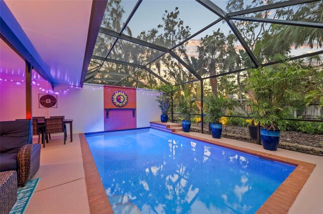 941 Virginia Dr, Sarasota, FL 34234 - pool at dusk featuring an outdoor pool and a lanai