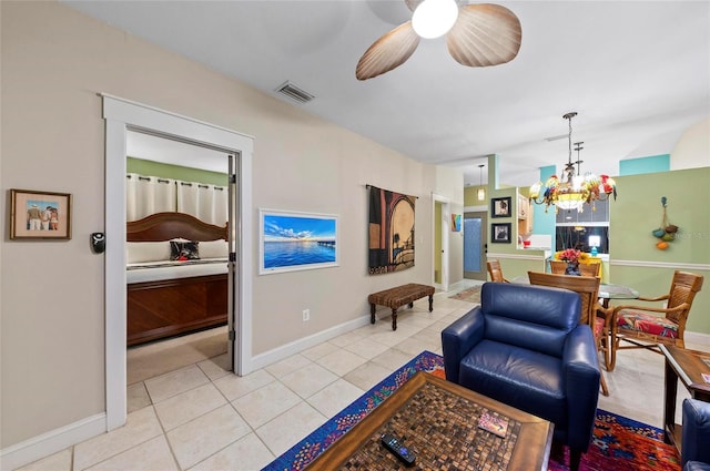 941 Virginia Dr, Sarasota, FL 34234 - living room featuring light tile patterned floors, a chandelier, baseboards, and a ceiling fan
