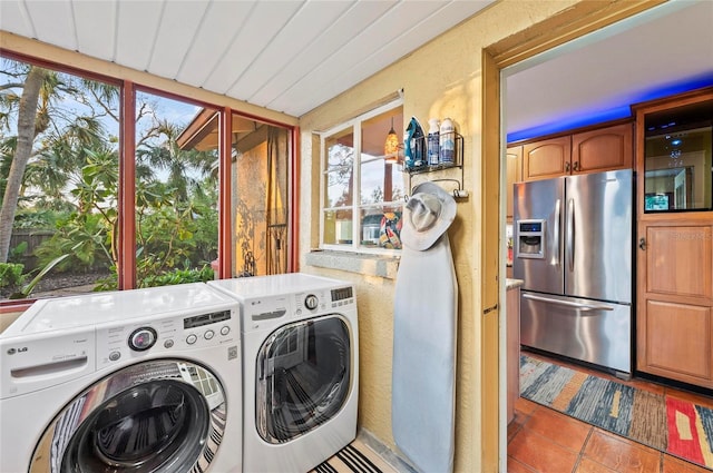 941 Virginia Dr, Sarasota, FL 34234 - clothes washing area featuring separate washer and dryer and tile patterned floors