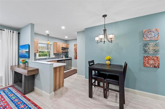 941 Virginia Dr, Sarasota, FL 34234 - kitchen featuring a chandelier, light countertops, tasteful backsplash, hanging light fixtures, and recessed lighting