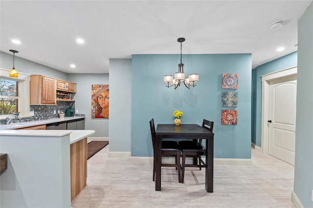 941 Virginia Dr, Sarasota, FL 34234 - kitchen with recessed lighting, light countertops, a chandelier, backsplash, and baseboards