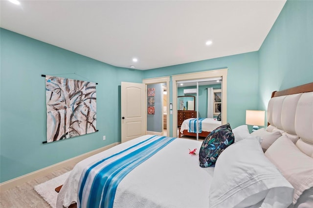 941 Virginia Dr, Sarasota, FL 34234 - bedroom with recessed lighting, wood finished floors, a wall mounted AC, and baseboards