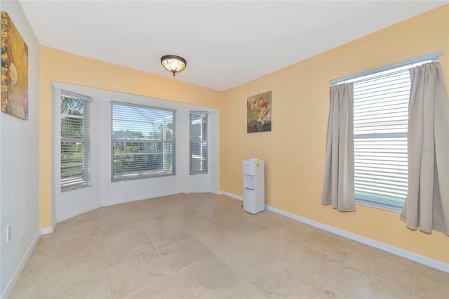 spare room featuring baseboards