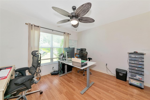 office with a ceiling fan, light wood finished floors, and baseboards