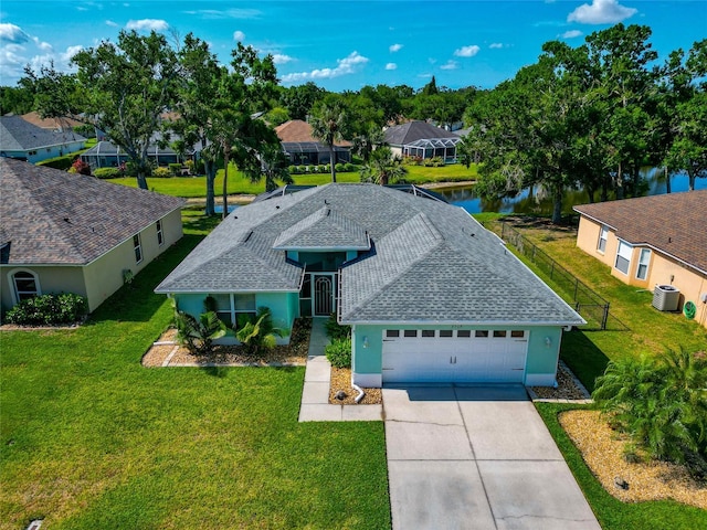 ranch-style house with cooling unit, a garage, a water view, concrete driveway, and roof with shingles