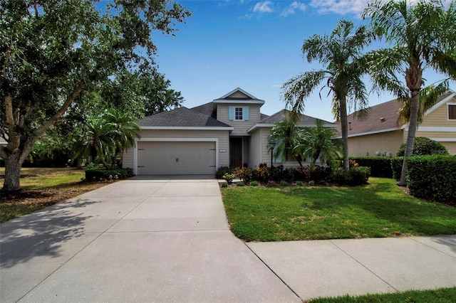 view of front facade featuring a garage, a front yard, driveway, and roof with shingles
