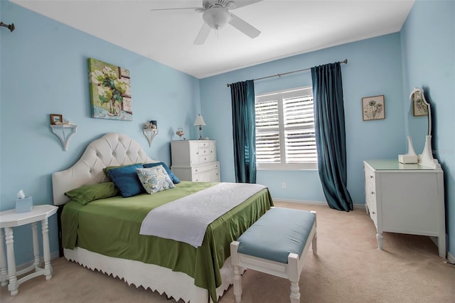 bedroom with light carpet, a ceiling fan, and baseboards