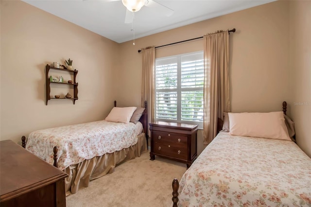 bedroom featuring light colored carpet and a ceiling fan