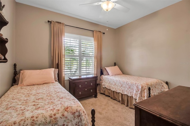 bedroom featuring light carpet and a ceiling fan