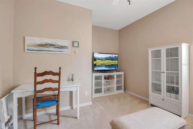 sitting room featuring carpet floors and baseboards