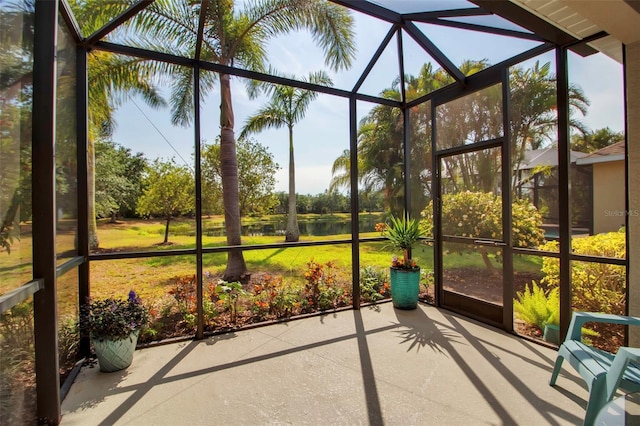 unfurnished sunroom with a water view
