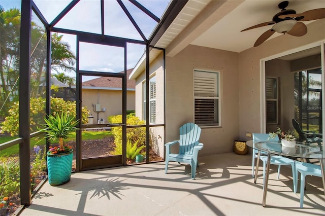 sunroom / solarium with a ceiling fan