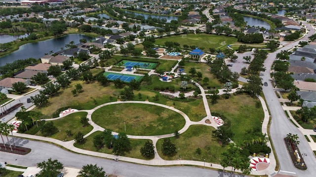 aerial view of property's location featuring a large body of water and nearby suburban area