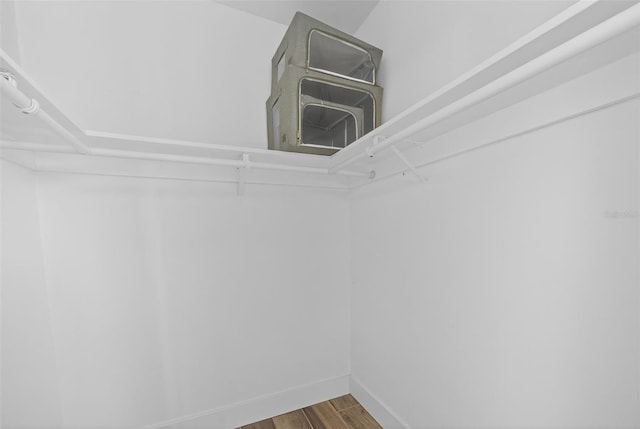 2733 Riverbluff Pl Unit V57, Sarasota, FL 34231 - walk in closet with wood finished floors