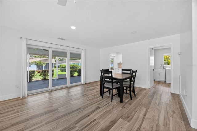 2733 Riverbluff Pl Unit V57, Sarasota, FL 34231 - dining area with light wood-style floors, ceiling fan, and recessed lighting