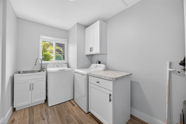 2733 Riverbluff Pl Unit V57, Sarasota, FL 34231 - laundry room featuring cabinet space, separate washer and dryer, and light wood-style flooring