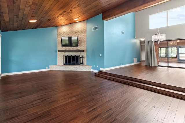 911 Cimarron Cir, Bradenton, FL 34209 - unfurnished living room featuring a chandelier, a fireplace, wood finished floors, wood ceiling, and high vaulted ceiling