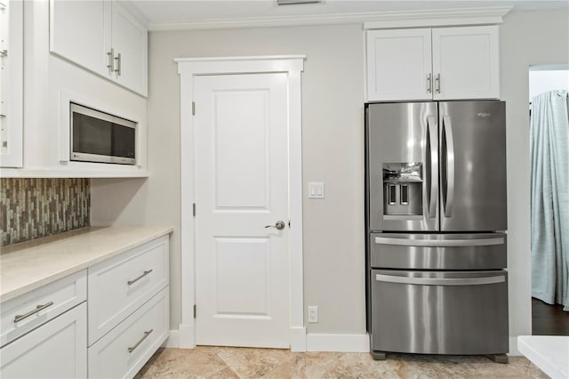 911 Cimarron Cir, Bradenton, FL 34209 - kitchen with stainless steel appliances, backsplash, white cabinetry, light countertops, and ornamental molding