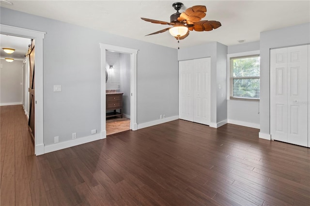 911 Cimarron Cir, Bradenton, FL 34209 - unfurnished bedroom with multiple closets, wood finished floors, and connected bathroom