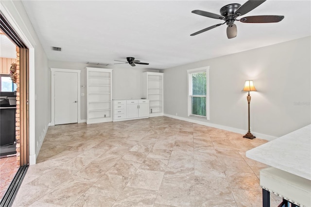 911 Cimarron Cir, Bradenton, FL 34209 - unfurnished living room featuring a ceiling fan and baseboards