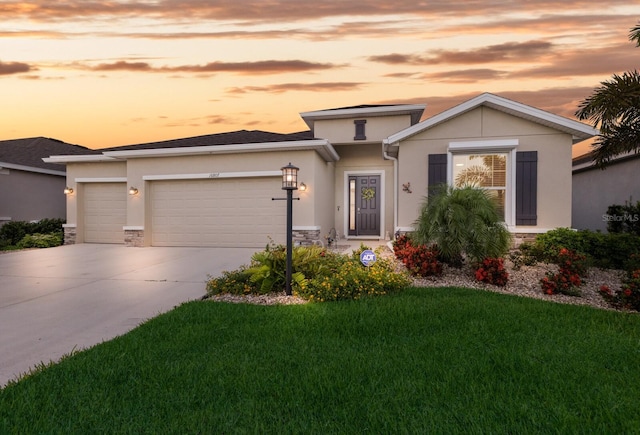 view of front of home featuring a garage, concrete driveway, stone siding, and stucco siding