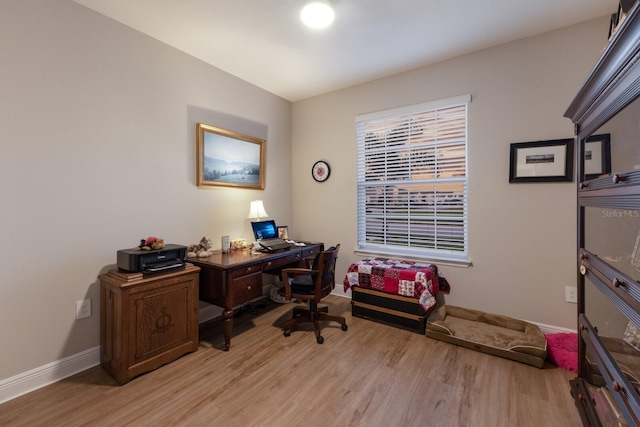 office space with light wood-style floors and baseboards