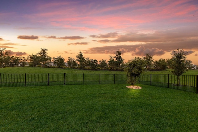 yard at dusk featuring a view of countryside