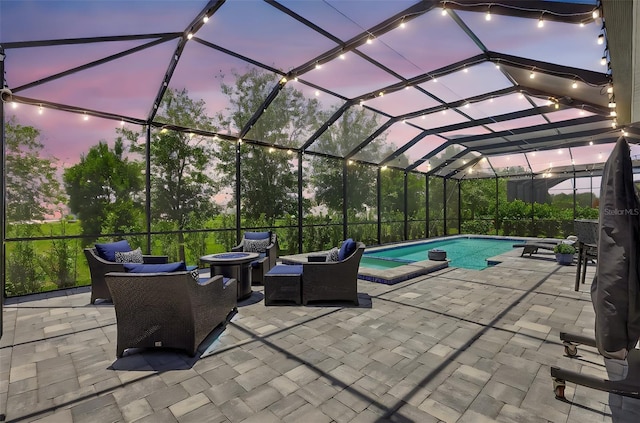 13918 Old Creek Ct, Parrish, FL 34219 - patio terrace at dusk featuring outdoor lounge area, a pool with connected hot tub, and a lanai