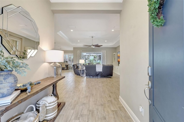 13918 Old Creek Ct, Parrish, FL 34219 - entryway featuring a tray ceiling, light wood-style floors, ceiling fan, recessed lighting, and baseboards