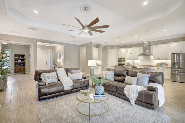13918 Old Creek Ct, Parrish, FL 34219 - living area with a ceiling fan, ornamental molding, light wood-style floors, recessed lighting, and a tray ceiling