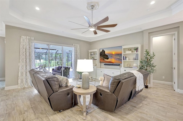 13918 Old Creek Ct, Parrish, FL 34219 - living area featuring a tray ceiling, a ceiling fan, baseboards, light wood-type flooring, and crown molding
