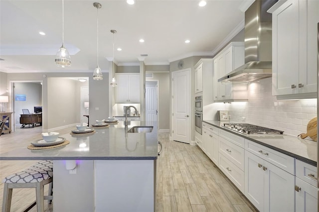 13918 Old Creek Ct, Parrish, FL 34219 - kitchen with a sink, wall chimney exhaust hood, stainless steel appliances, crown molding, and backsplash