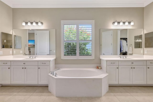 13918 Old Creek Ct, Parrish, FL 34219 - bathroom featuring tile patterned floors, a garden tub, two vanities, and ornamental molding