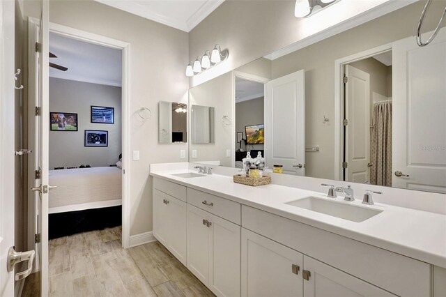 13918 Old Creek Ct, Parrish, FL 34219 - full bathroom with ensuite bath, crown molding, baseboards, double vanity, and wood finished floors