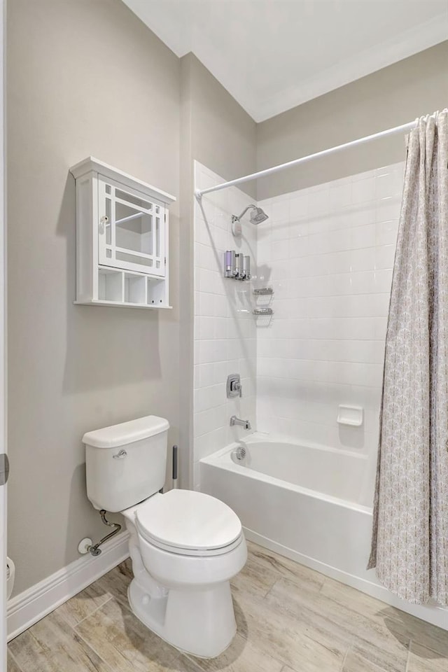13918 Old Creek Ct, Parrish, FL 34219 - bathroom with toilet, shower / bath combo with shower curtain, wood finished floors, and baseboards