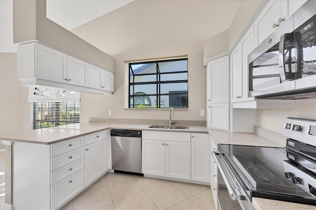 4517 Las Brisas Ln, Sarasota, FL 34238 - kitchen featuring stainless steel appliances, a sink, a peninsula, and white cabinetry