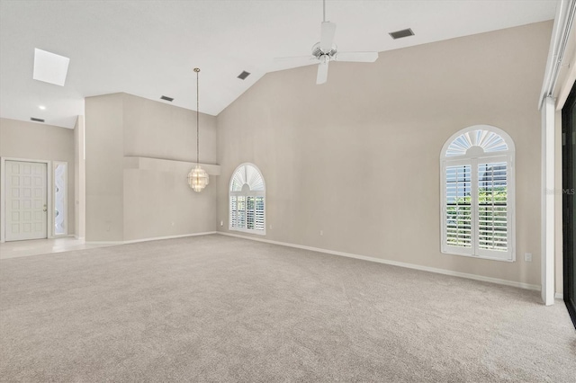 4517 Las Brisas Ln, Sarasota, FL 34238 - carpeted empty room with high vaulted ceiling, healthy amount of natural light, a chandelier, a ceiling fan, and baseboards