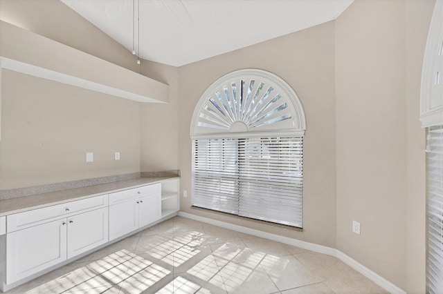 4517 Las Brisas Ln, Sarasota, FL 34238 - unfurnished dining area with vaulted ceiling, baseboards, and light tile patterned floors