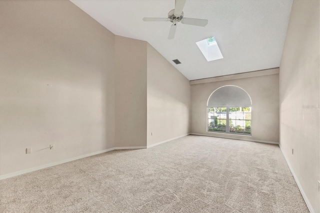 4517 Las Brisas Ln, Sarasota, FL 34238 - spare room with a skylight, vaulted ceiling, carpet, a ceiling fan, and baseboards