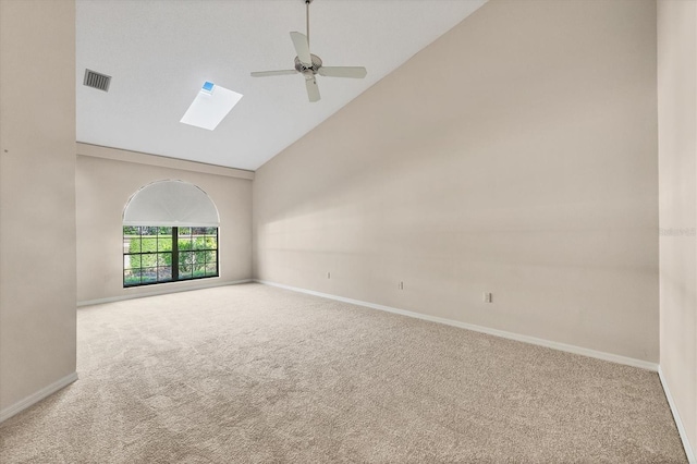 4517 Las Brisas Ln, Sarasota, FL 34238 - empty room with carpet floors, ceiling fan, a skylight, high vaulted ceiling, and baseboards