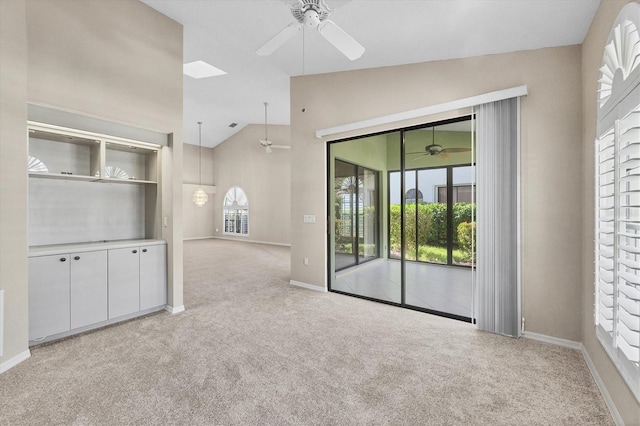 4517 Las Brisas Ln, Sarasota, FL 34238 - carpeted empty room featuring ceiling fan, baseboards, and high vaulted ceiling