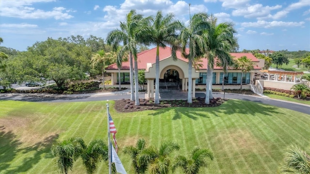 4517 Las Brisas Ln, Sarasota, FL 34238 - mediterranean / spanish house featuring a front lawn and stucco siding