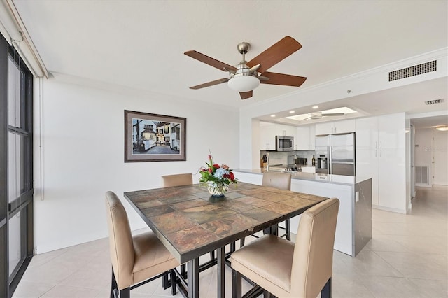 dining room featuring a ceiling fan, light tile patterned floors, recessed lighting, and crown molding