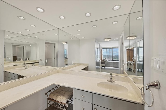ensuite bathroom with recessed lighting and vanity