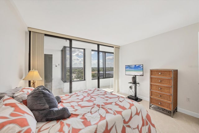 bedroom with baseboards, floor to ceiling windows, and tile patterned floors