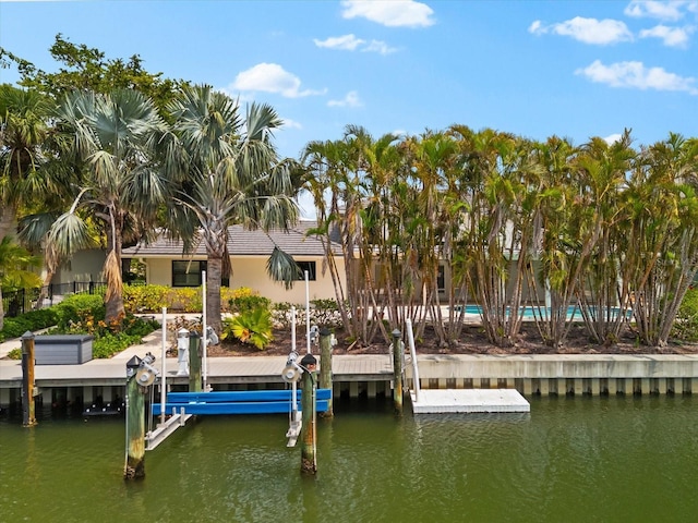 dock area featuring a water view, boat lift, and fence