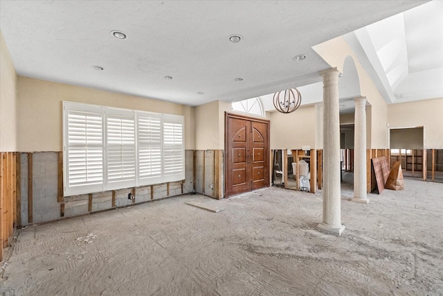unfurnished living room with decorative columns and recessed lighting