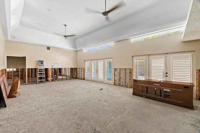 misc room featuring ceiling fan and a high ceiling